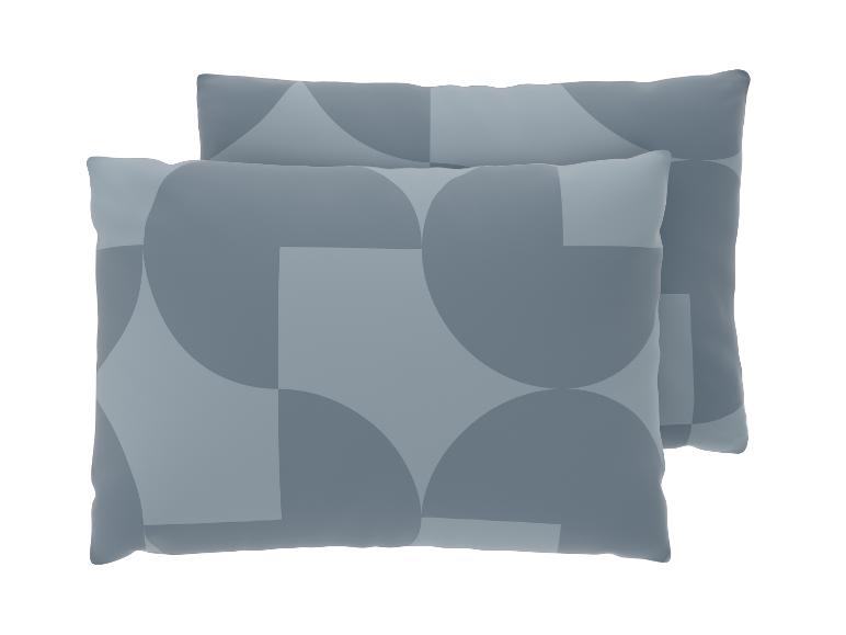 Deux coussins décoratifs gris avec un motif géométrique de cercles et de carrés.