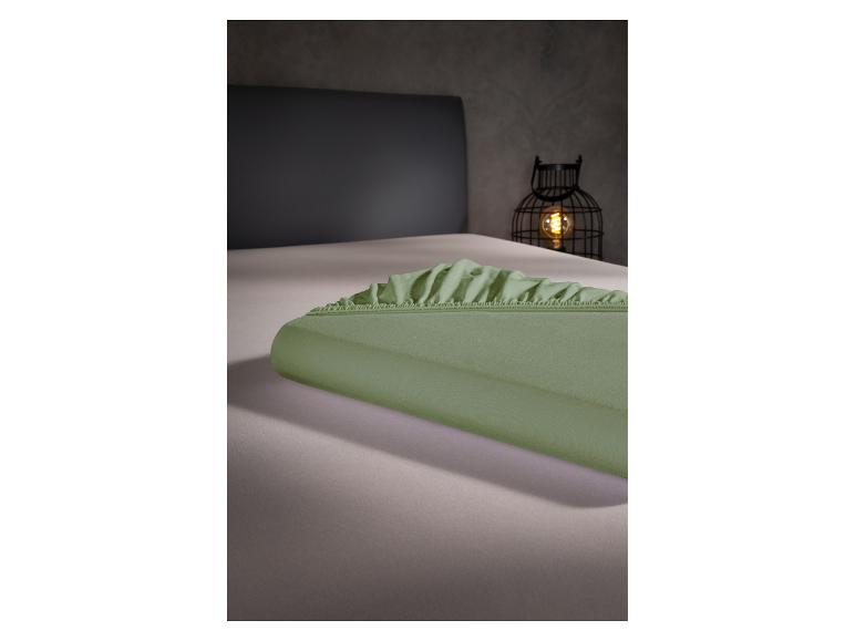 Draps verts sur un lit.