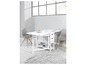Une table à manger blanche avec deux chaises et un rangement.