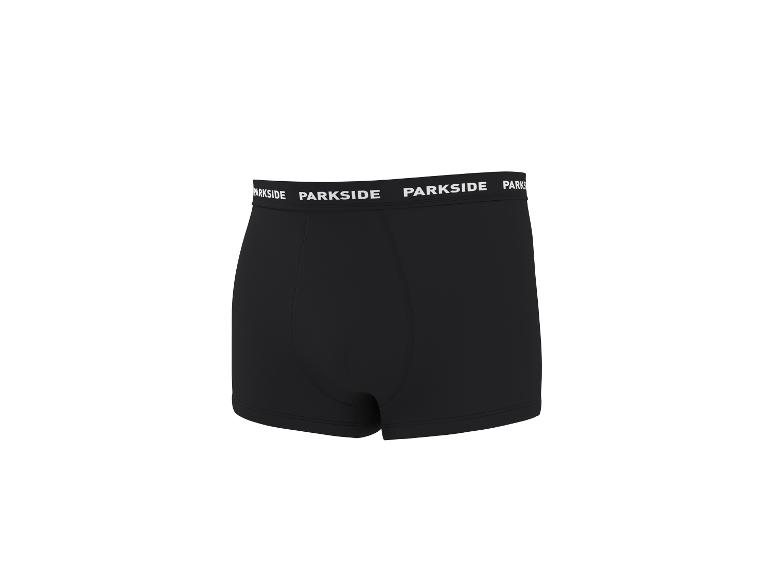 Caleçon boxer noir pour homme avec une ceinture élastique blanche à motif textuel répété.