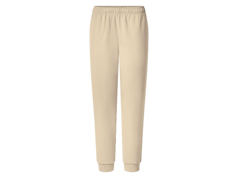 Pantalon de jogging beige avec taille élastique et poignets côtelés.