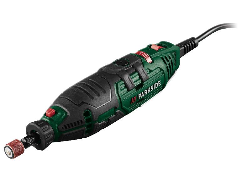 Outil rotatif vert et noir avec accessoire de ponçage et cordon d'alimentation.