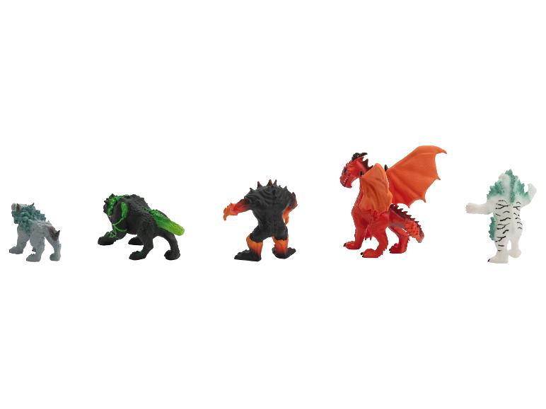 Cinq figurines colorées de monstres et de dragons, alignées sur un fond blanc.