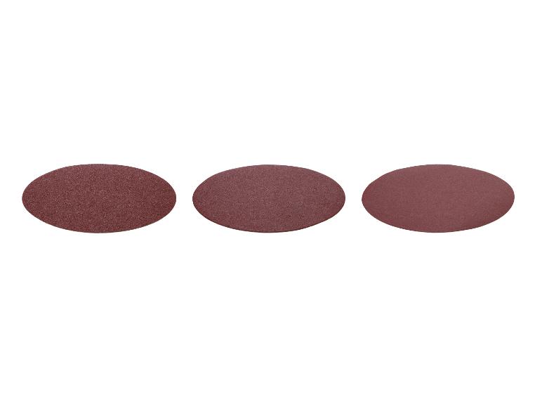 Trois disques abrasifs ronds de couleur marron sur fond blanc