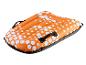 Luge gonflable orange avec motif hexagonal blanc et poignées noires.