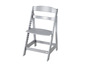 Une chaise haute Stokke Tripp Trapp argentée.