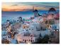 Maisons blanches avec des moulins à vent au coucher du soleil à Santorin.