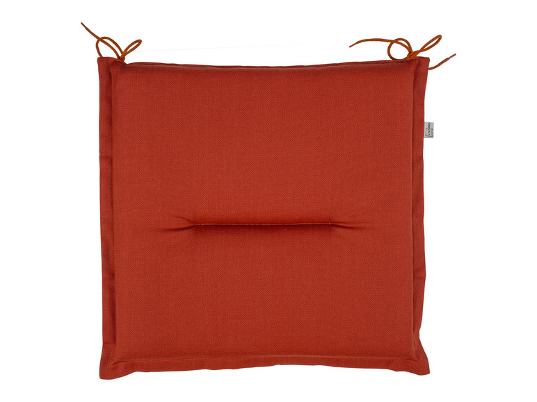 Un coussin de chaise orange Livarno Living avec des cordons.