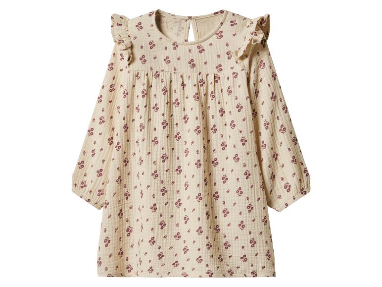Robe beige à manches longues avec volants aux épaules et motif floral.