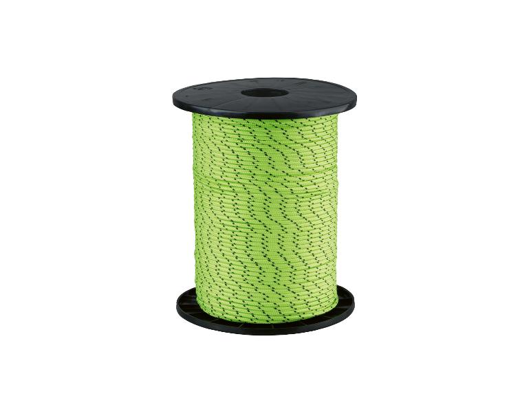 Bobine de corde verte à pois noirs sur fond blanc.