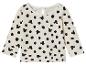 Un t-shirt à manches longues blanc avec des pois noirs et un imprimé Mickey Mouse.