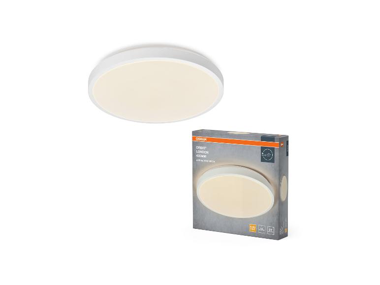 Un plafonnier rond blanc et son emballage, avec des informations sur le luminaire.