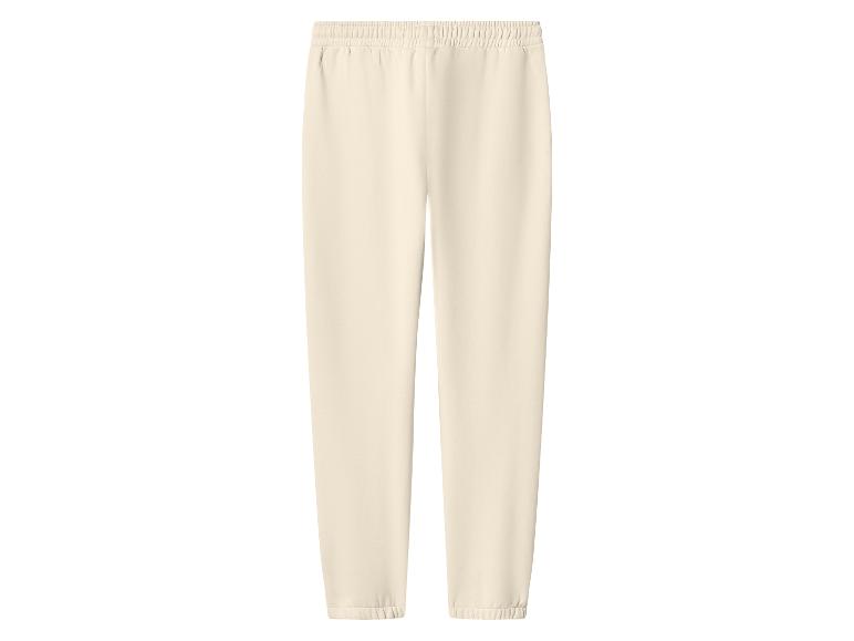 Pantalon de jogging beige clair avec taille élastique et chevilles resserrées.