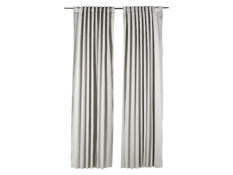 Une paire de rideaux gris clair suspendus à une tringle.