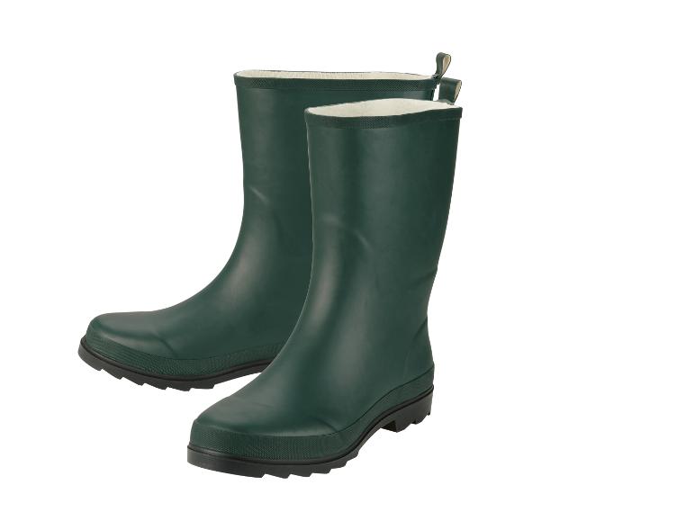 Une paire de bottes en caoutchouc vertes avec doublure blanche