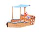 Bac à sable en bois en forme de bateau avec auvent bleu, volant et bouée de sauvetage