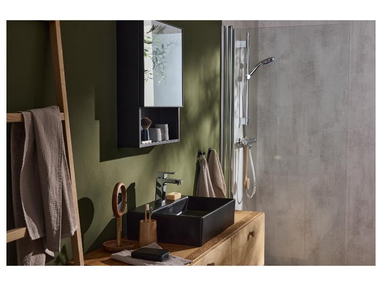 Salle de bain moderne avec lavabo noir, armoire miroir et cabine de douche.