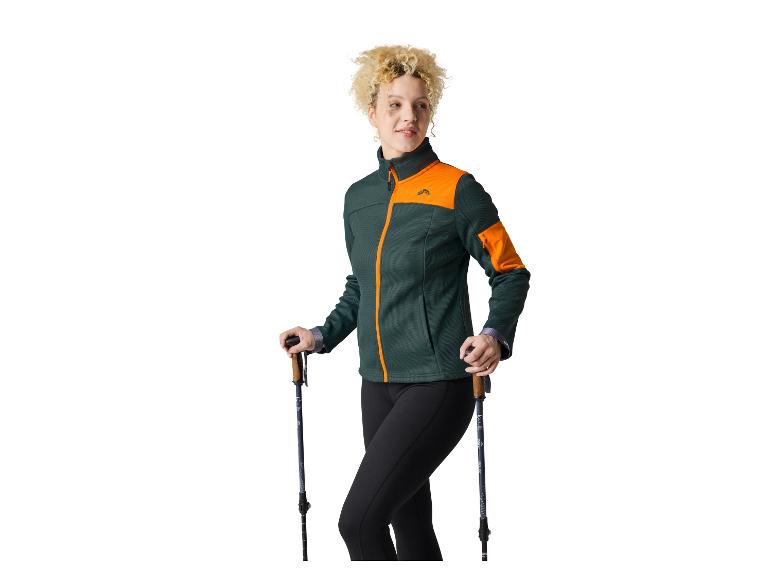 Femme portant une veste Craft et des bâtons de randonnée.
