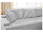 Canapé modulaire gris clair avec coussins en velours côtelé dans un salon lumineux.