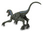 Une figurine de dinosaure en jouet verte, bleue et grise.