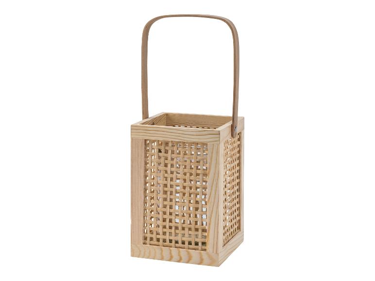 Une lanterne en bois avec une poignée et un motif tressé.