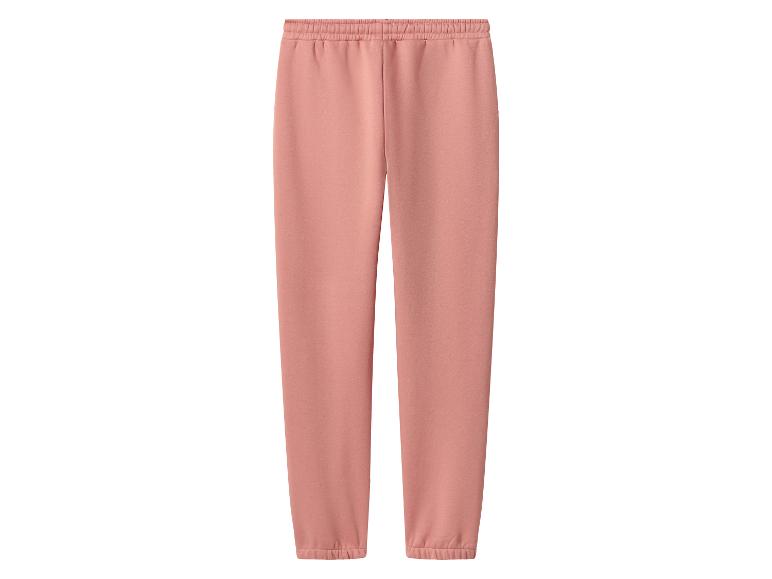 Pantalon de survêtement rose pêche avec taille élastique et chevilles resserrées.