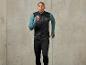 Un homme portant un gilet de course noir et un pantalon de course noir.
