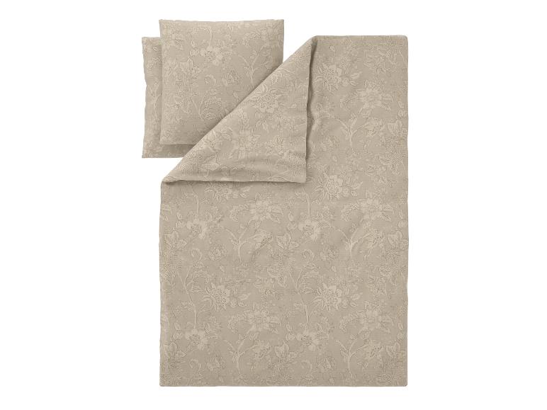 Parure de lit beige avec housse de couette et taie d'oreiller à motif floral.