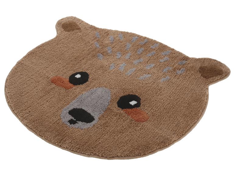 Tapis marron en forme d'ours avec yeux et nez brodés.