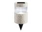 Spot solaire LED à planter avec boîtier transparent nervuré et texture couleur sable.