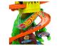 Ensemble de jeu Hot Wheels sur le thème des dinosaures avec voitures de course.