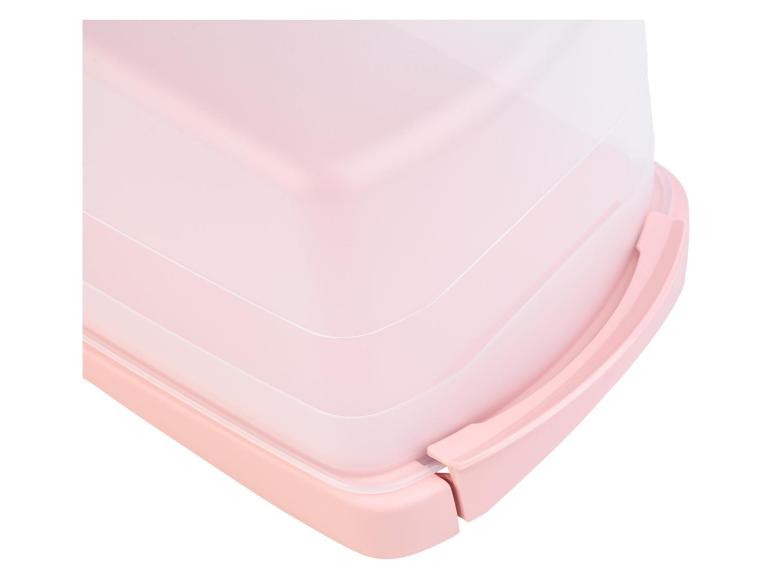 Boîte à gâteau en plastique rose avec couvercle.