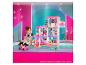 Fille jouant avec une maison de rêve Barbie et des poupées Barbie.