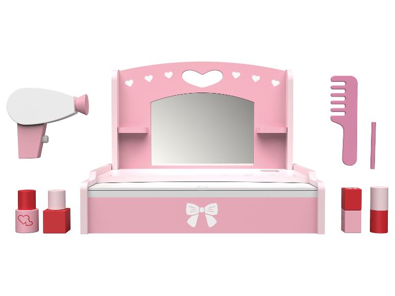 Ensemble de jeu de maquillage rose avec miroir, sèche-cheveux et accessoires.