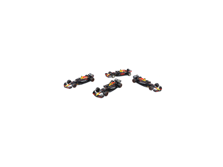 Quatre voitures de course miniatures aux livrées noires, rouges et jaunes, disposées sur une surface blanche.
