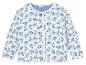 Veste matelassée à fleurs bleues sur fond blanc.