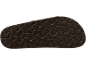 Gros plan d'une semelle de sandale marron foncé avec un motif texturé et ondulé.