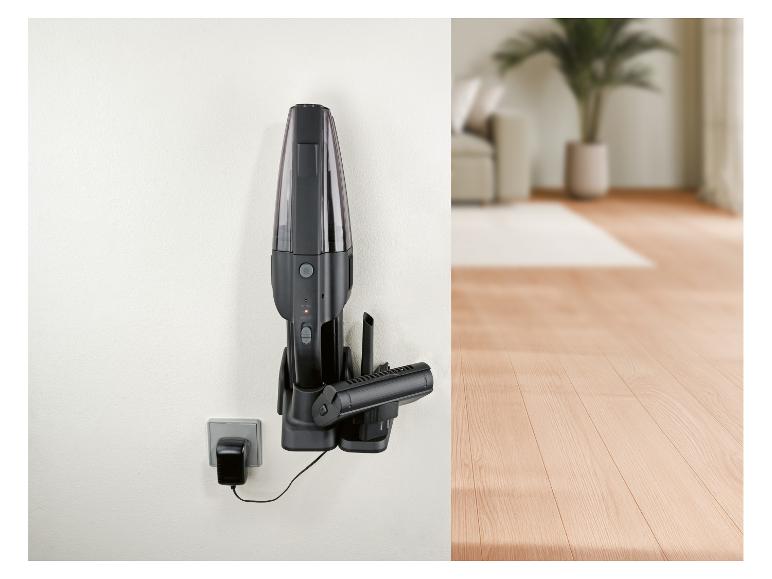 Aspirateur à main noir mural avec chargeur dans un intérieur moderne.