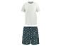 T-shirt blanc et short de pyjama vert foncé à motif de palmiers.