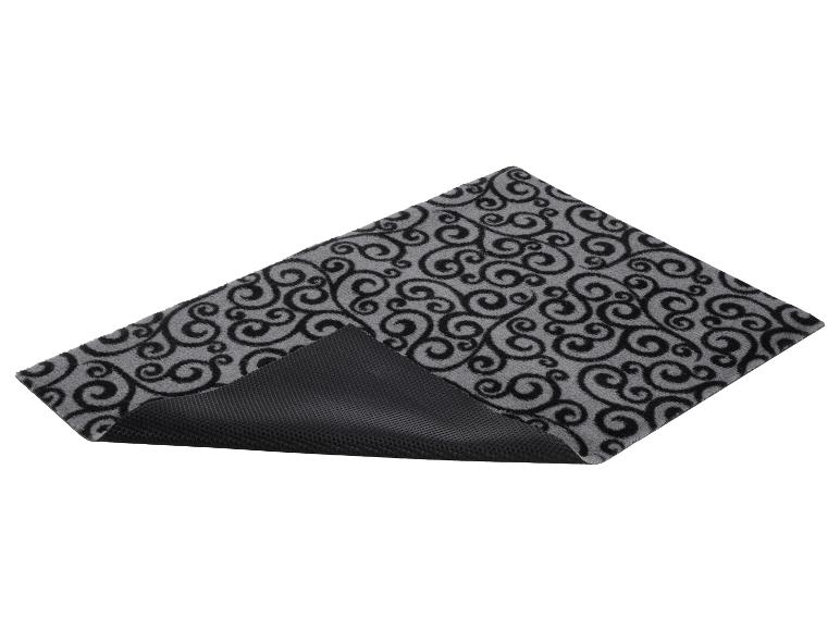 Tapis gris avec motif en spirale noir et base antidérapante