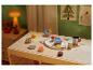 Service à thé en bois pour enfants LUPILU sur une table de jeu.