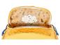Intérieur d'un sac à dos jaune avec fermeture éclair, doublure à motif forestier et étiquette de nom.