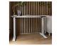 Bureau blanc réglable en hauteur avec mur à lattes en bois et plantes.