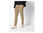 Pantalon beige en velours côtelé et baskets blanches.