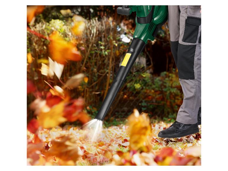 Une personne utilise un souffleur à feuilles Parkside pour nettoyer son jardin des feuilles mortes.