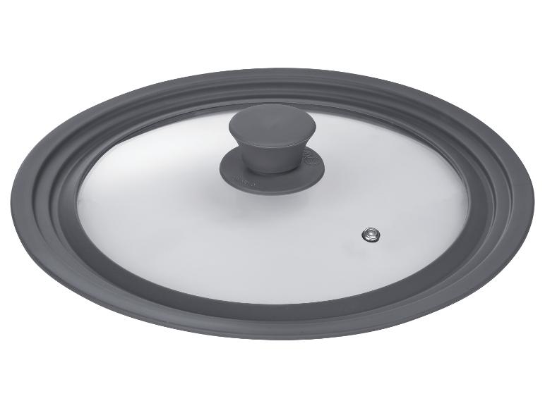Un couvercle en verre avec une bordure grise et un bouton pour une casserole.