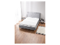 Matelas et sommier gris clair dans une chambre moderne.