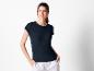 Une femme porte un t-shirt bleu marine à manches courtes.