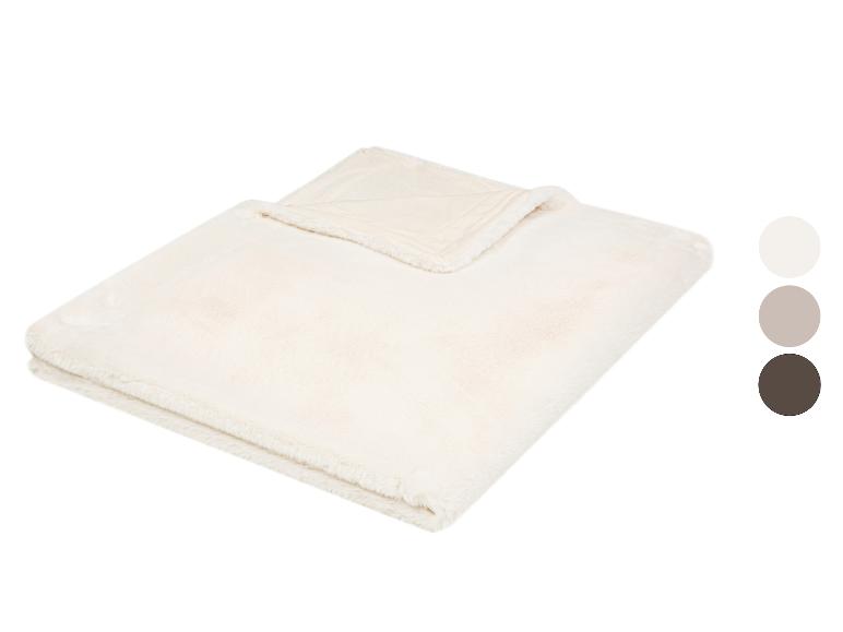 Couverture crème et moelleuse avec trois échantillons de couleurs : blanc, beige et marron.