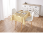 Une table à manger avec une nappe dorée, des chaises blanches et un buffet.